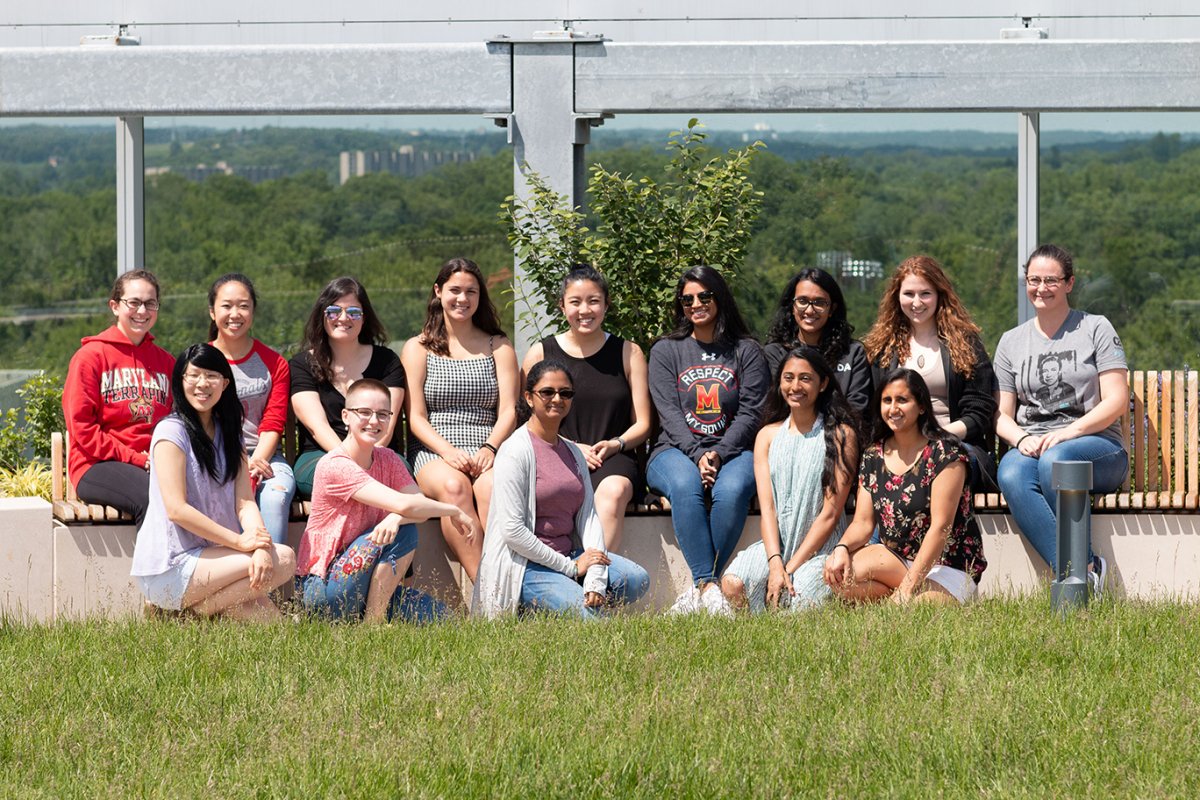 group of women students seated on the roof of the Iribe Center